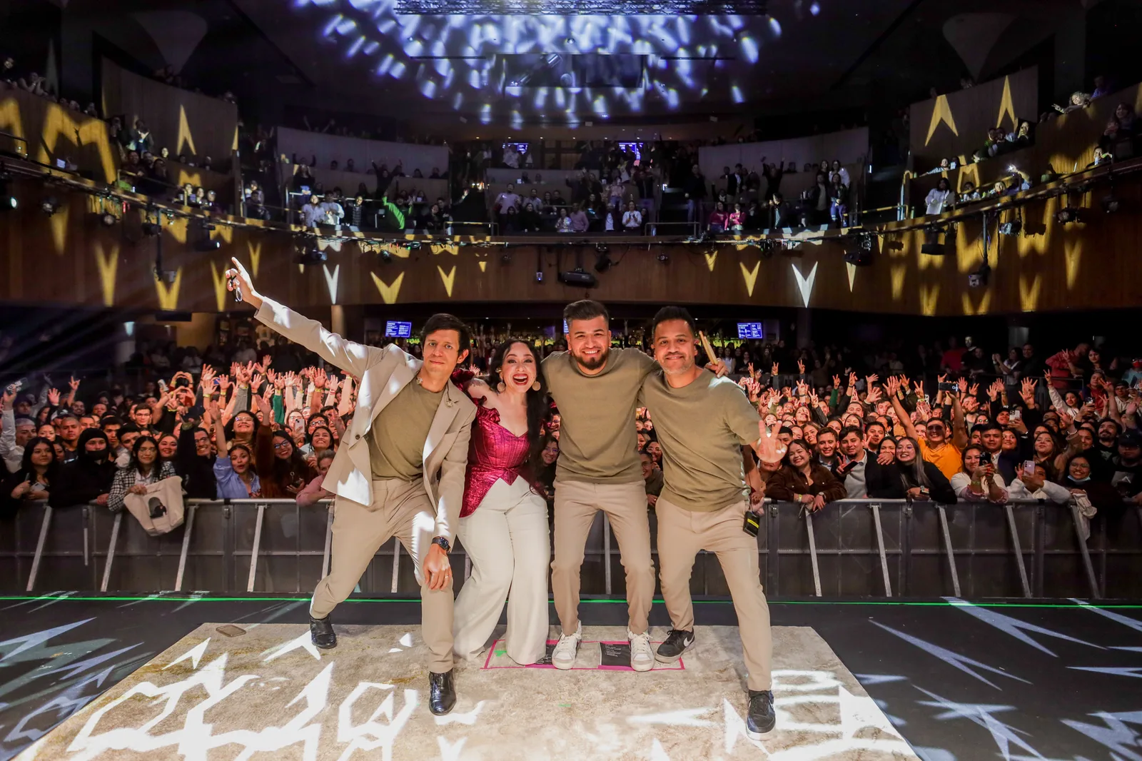 LIVEST team backstage with the crowd behind them.