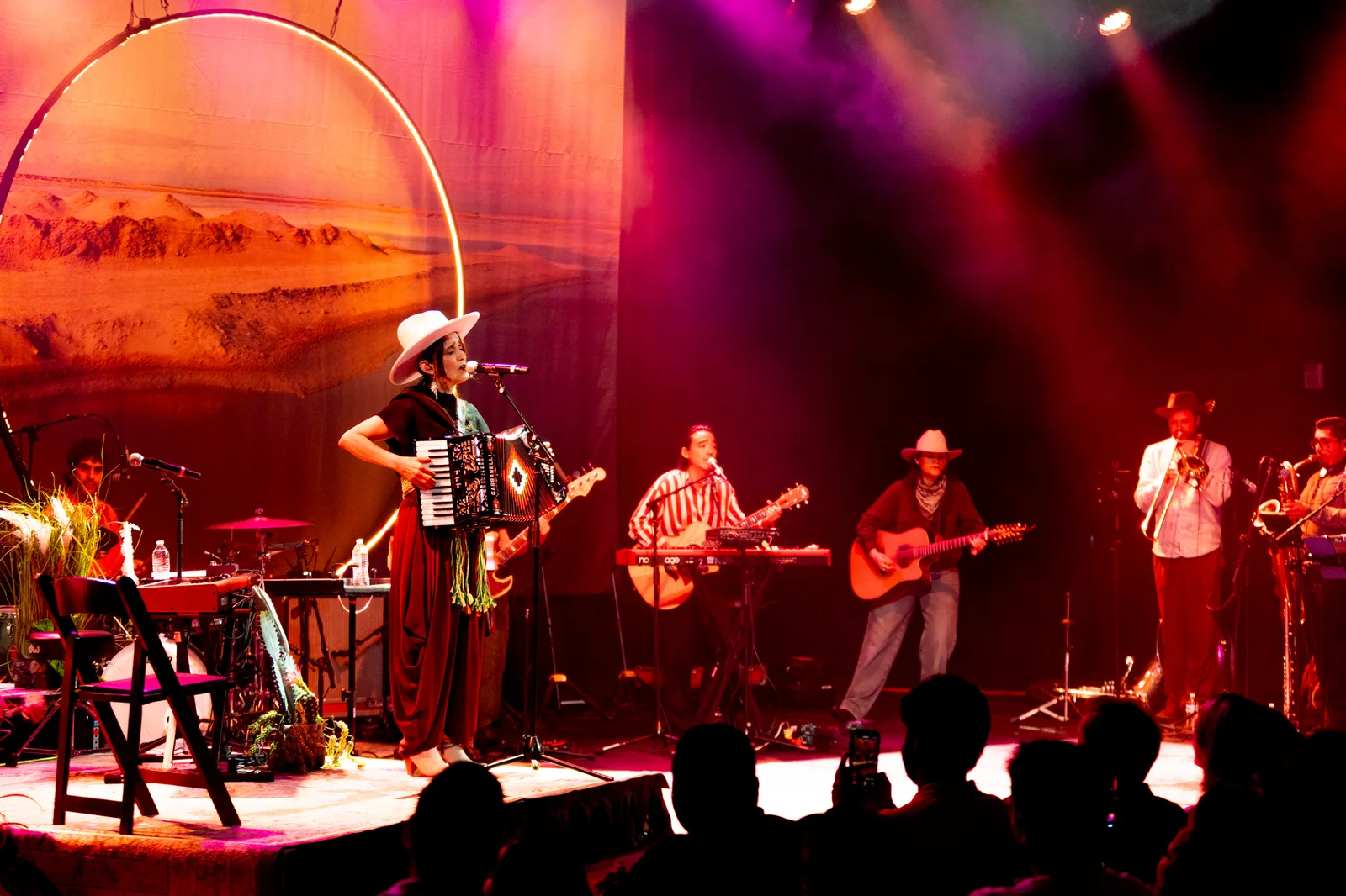 Band performing on stage under warm stage lighting at a LIVEST show.